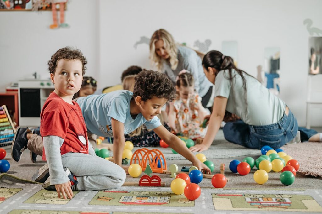 pexels-photo-8422255 Kids engaging in play and learning activities at a kindergarten. Fun and colorful environment.